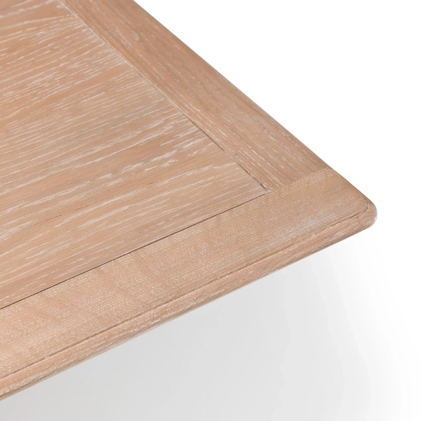 Close-up of light oak dining table corner showing wood grain and beveled edge