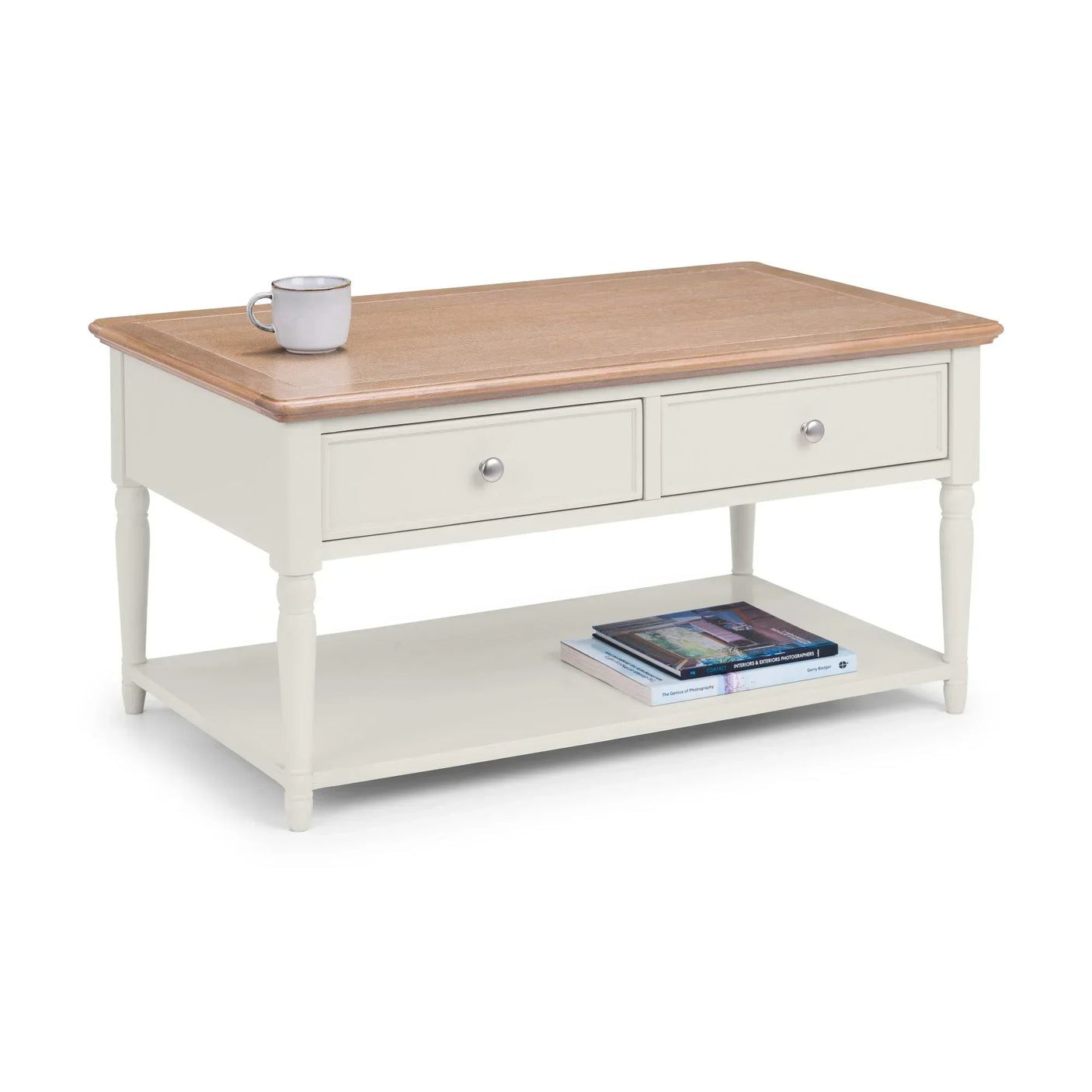 Cream and oak coffee table with two drawers, lower shelf, cup and books on display
