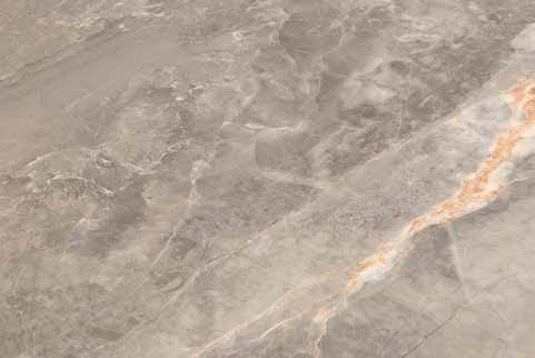Marble dining table surface with light grey and brown veining, close-up detail