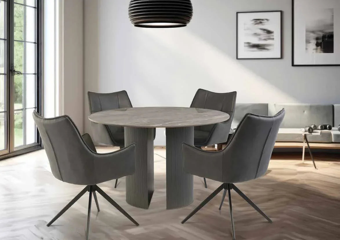 Round dining table with grey upholstered swivel chairs in modern living space