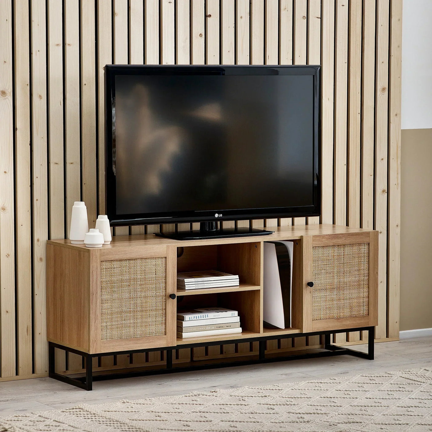 Oak TV unit with cane panel doors, open shelves, and black frame in modern living room
