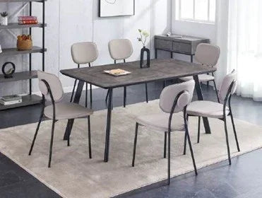 Modern dining table set with six grey upholstered chairs on a light rug in a bright room
