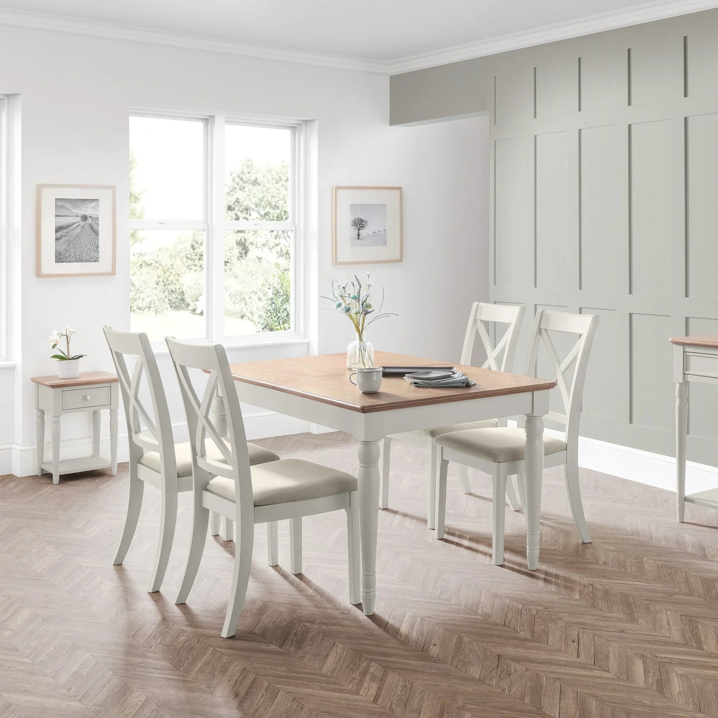 Provence dining set with four white chairs and wooden table in a bright dining room