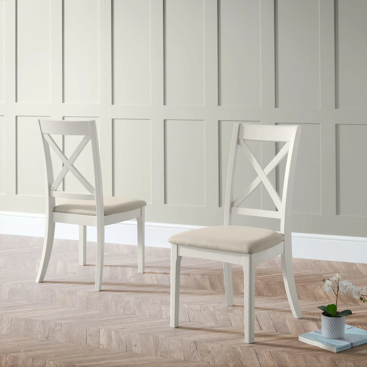 Provence dining chairs with cream upholstered seat and white wood frame in minimalist room