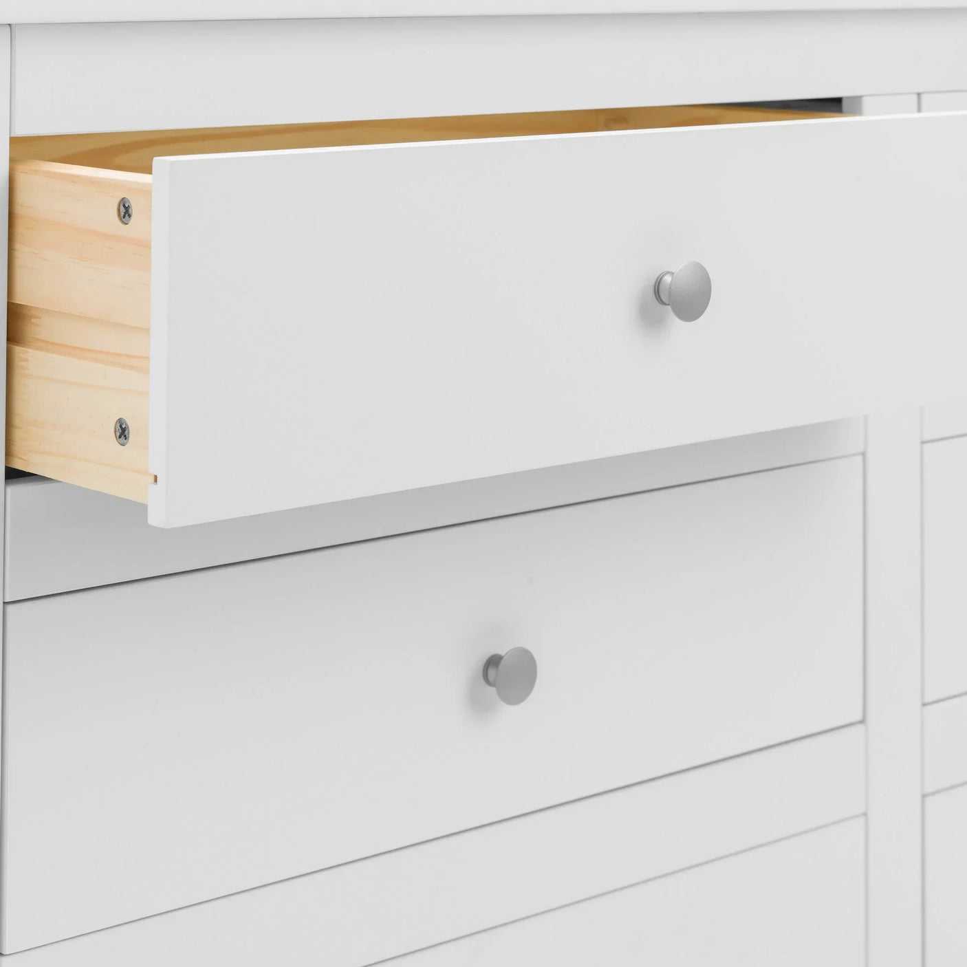 White wooden chest of drawers with one open drawer showing natural wood interior