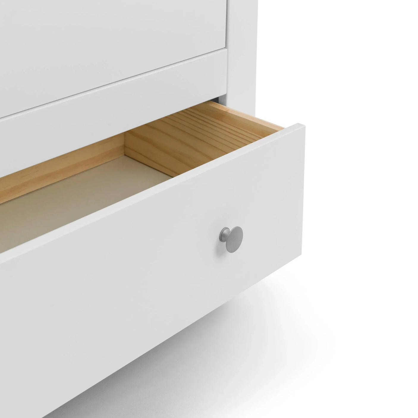 White wooden chest of drawers open to show natural wood interior and round metal handle