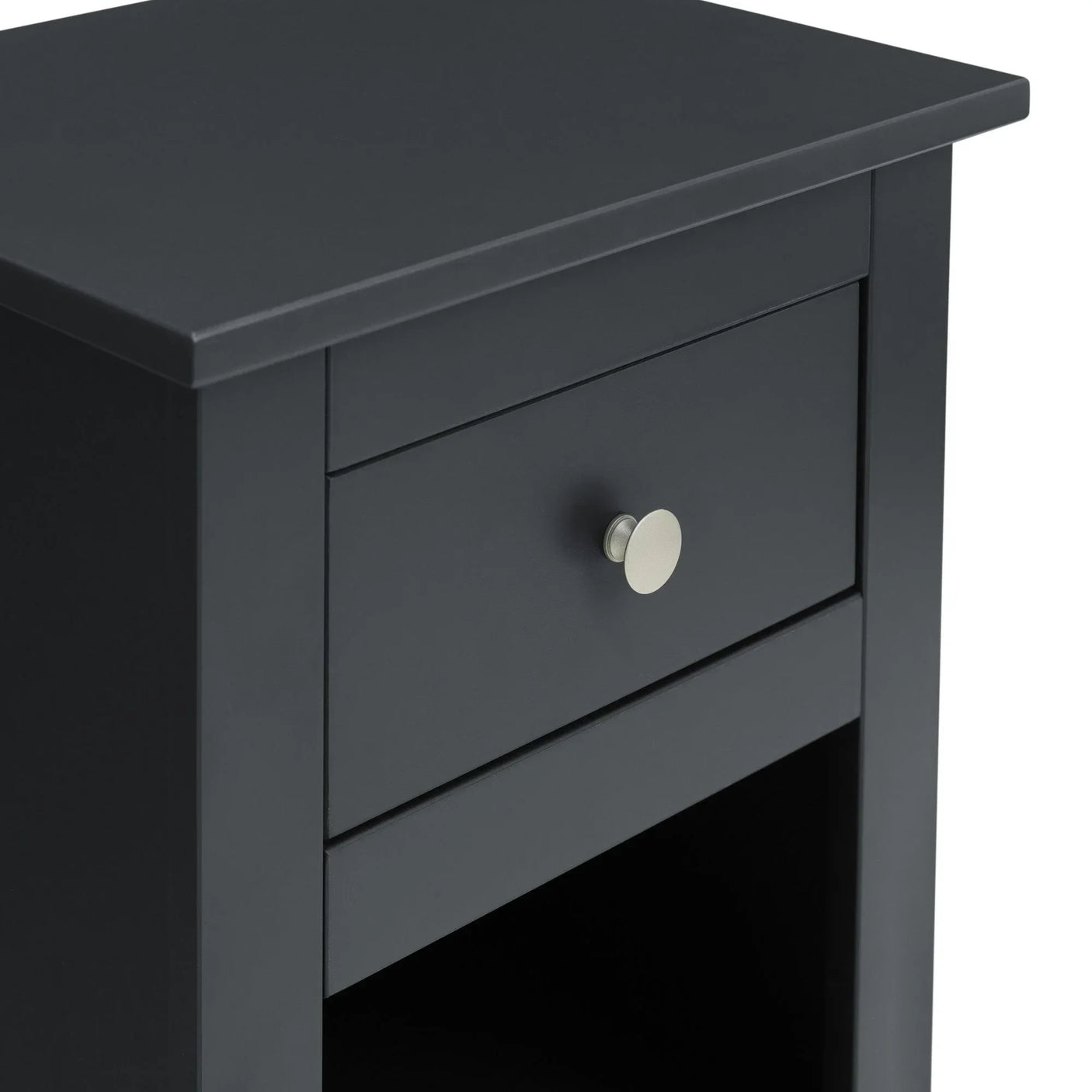 Black bedside table with drawer and silver handle, close view of top and storage shelf