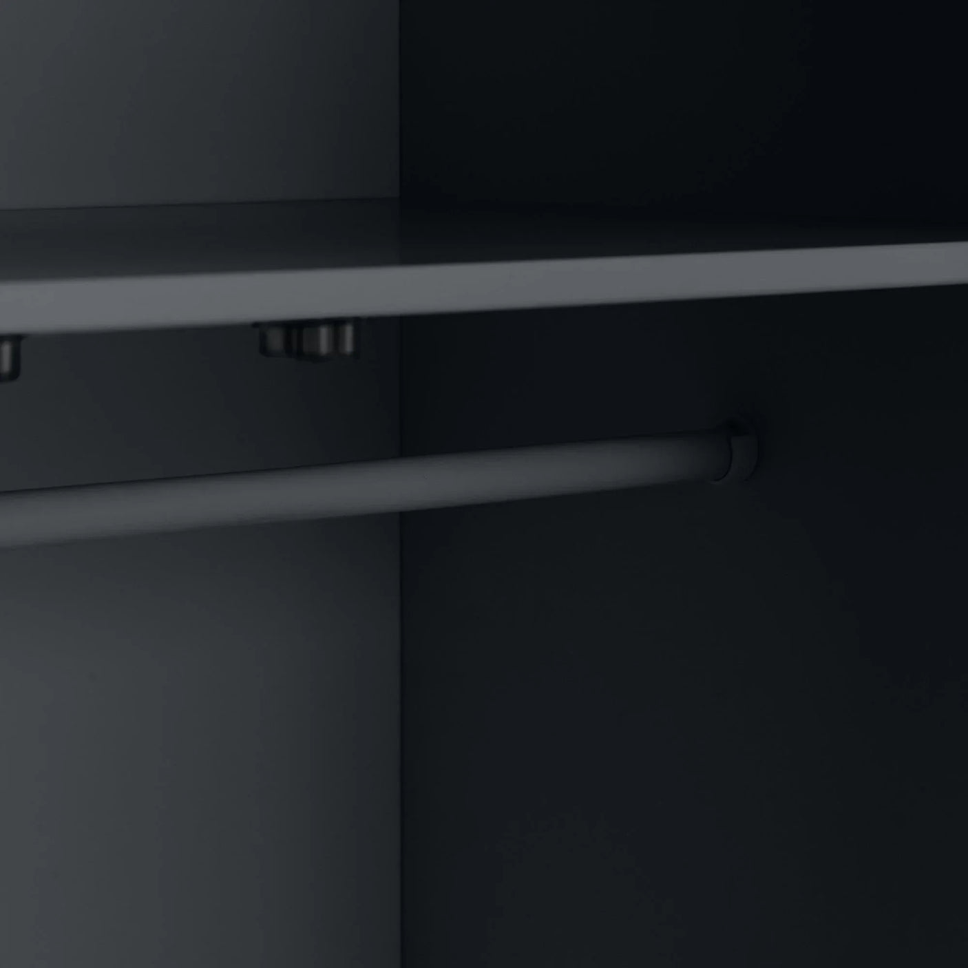 Interior view of wardrobe showing matte black shelf and hanging rail