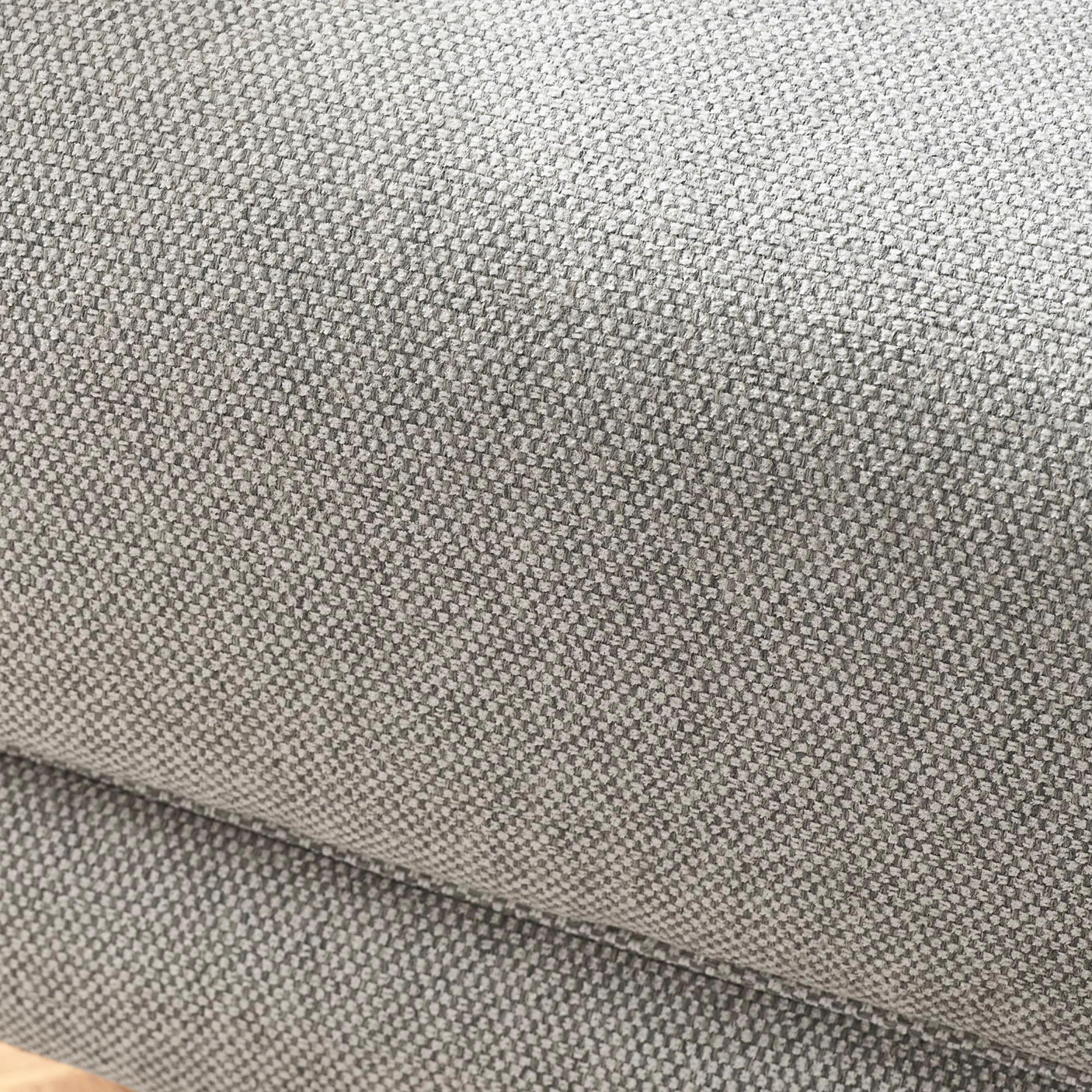 Close-up of grey fabric sofa upholstery with textured weave detail