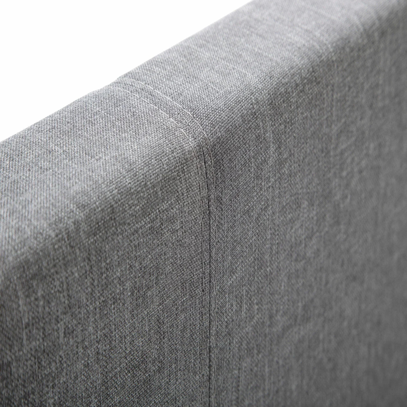 Light grey linen single bed headboard detail with visible stitching