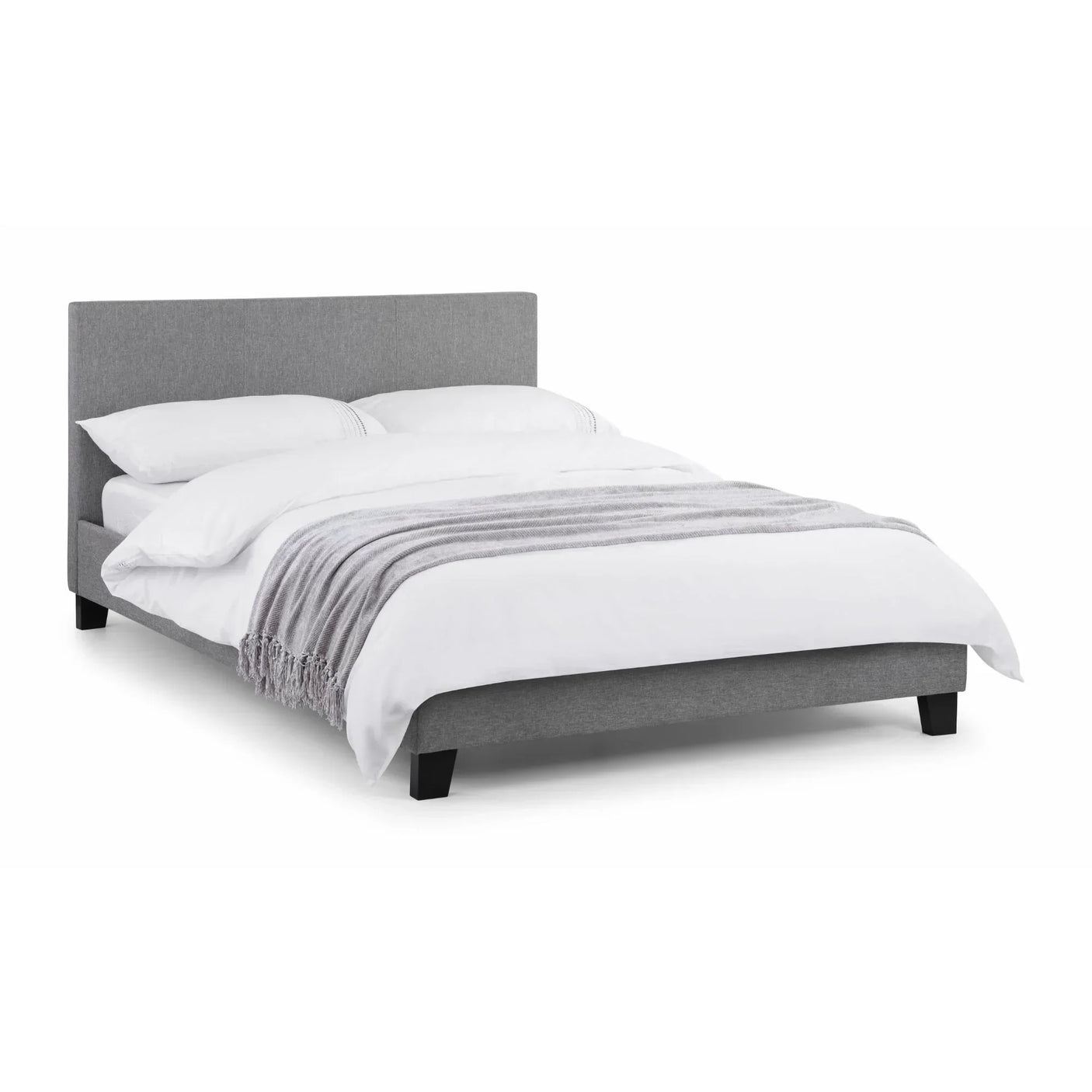 Grey upholstered bed frame with low headboard, white bedding, and striped throw blanket