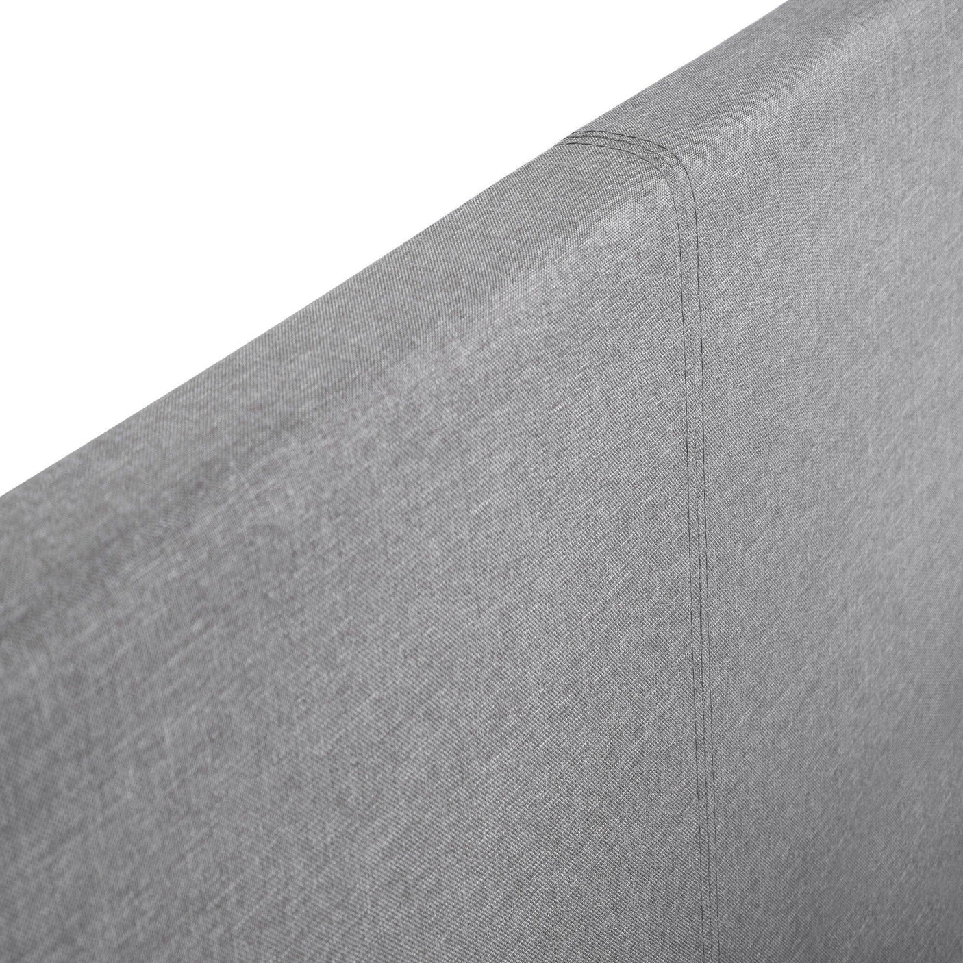 Close-up of grey fabric headboard on storage bed, showing stitching and texture detail