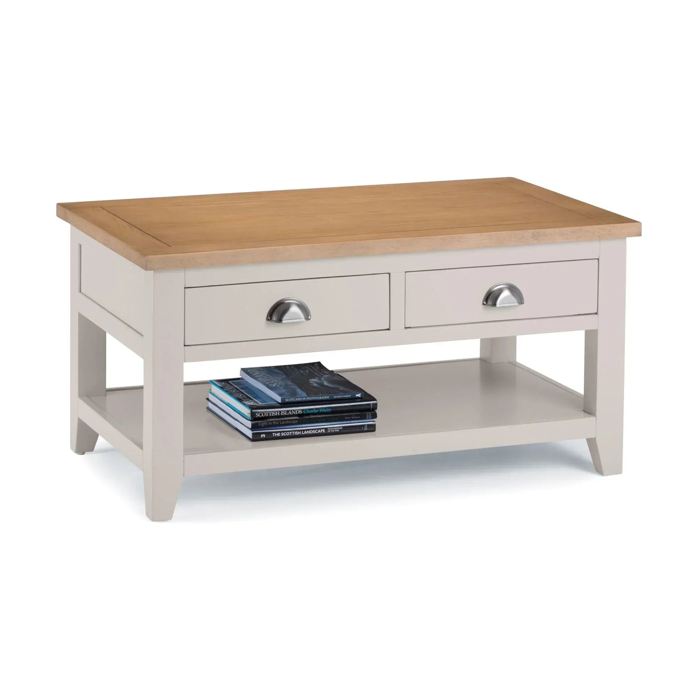 Wooden coffee table with light oak top, two drawers, lower shelf and books displayed