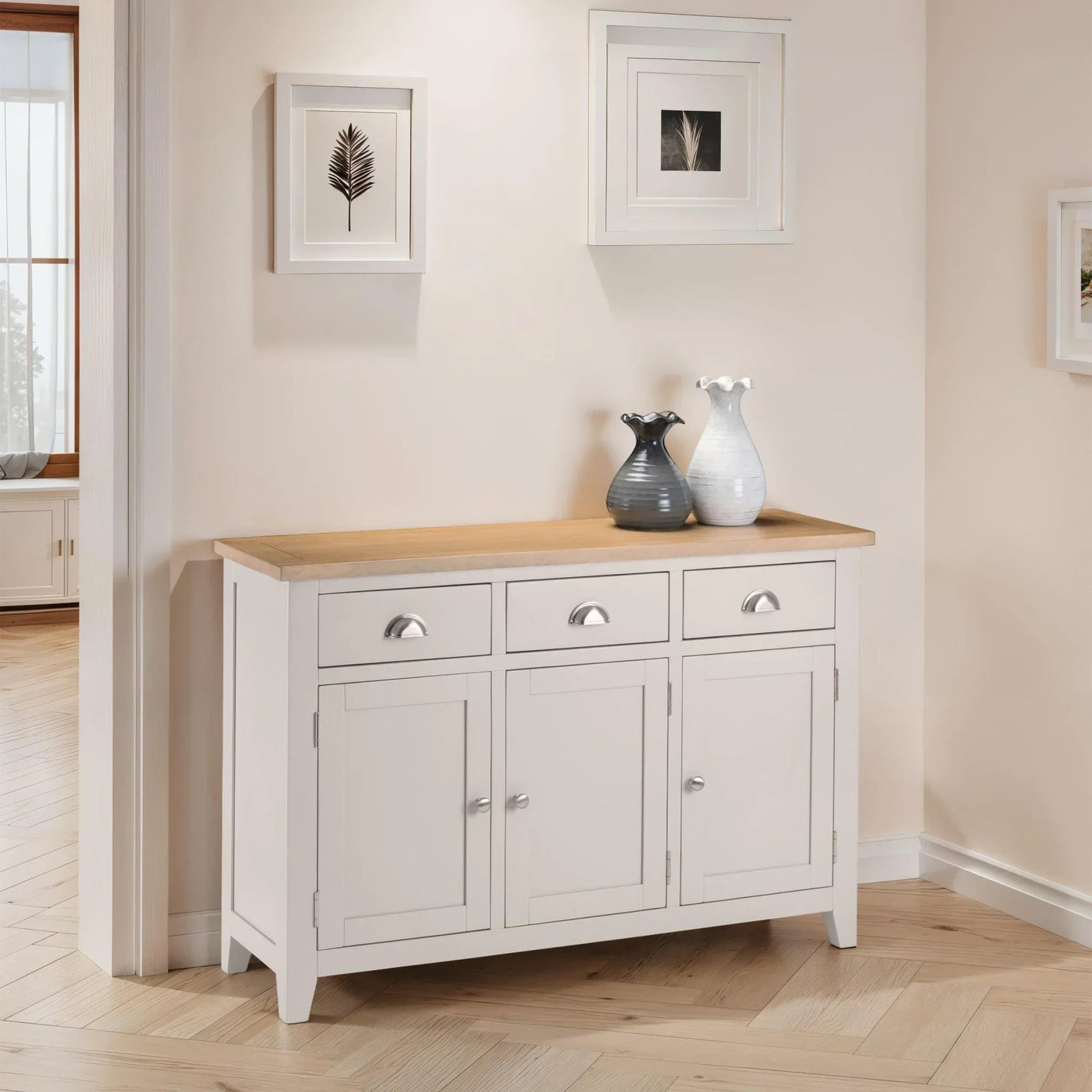 White sideboard with oak top, three drawers, three doors, and vases in modern hallway