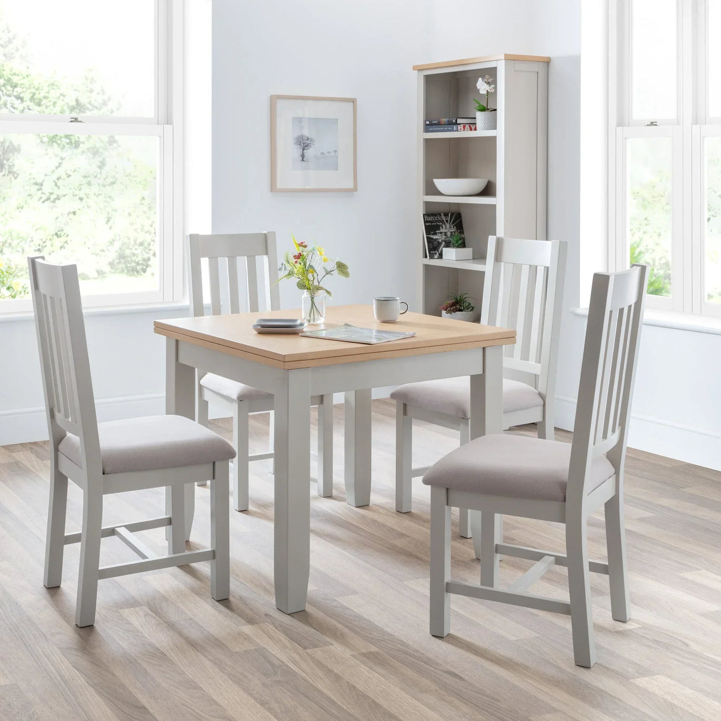 Light oak and grey dining table set with four chairs in bright modern dining room