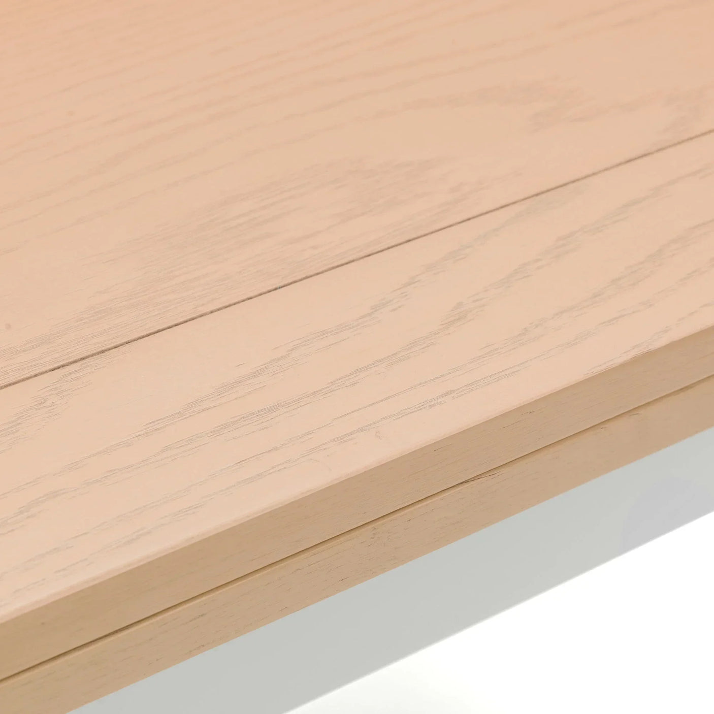 Closeup of light oak dining table top showing natural wood grain texture