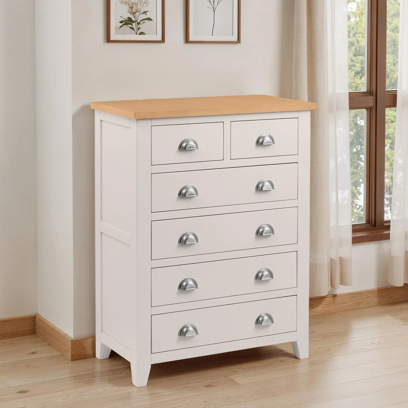 White chest of drawers with silver handles and oak top in bright bedroom