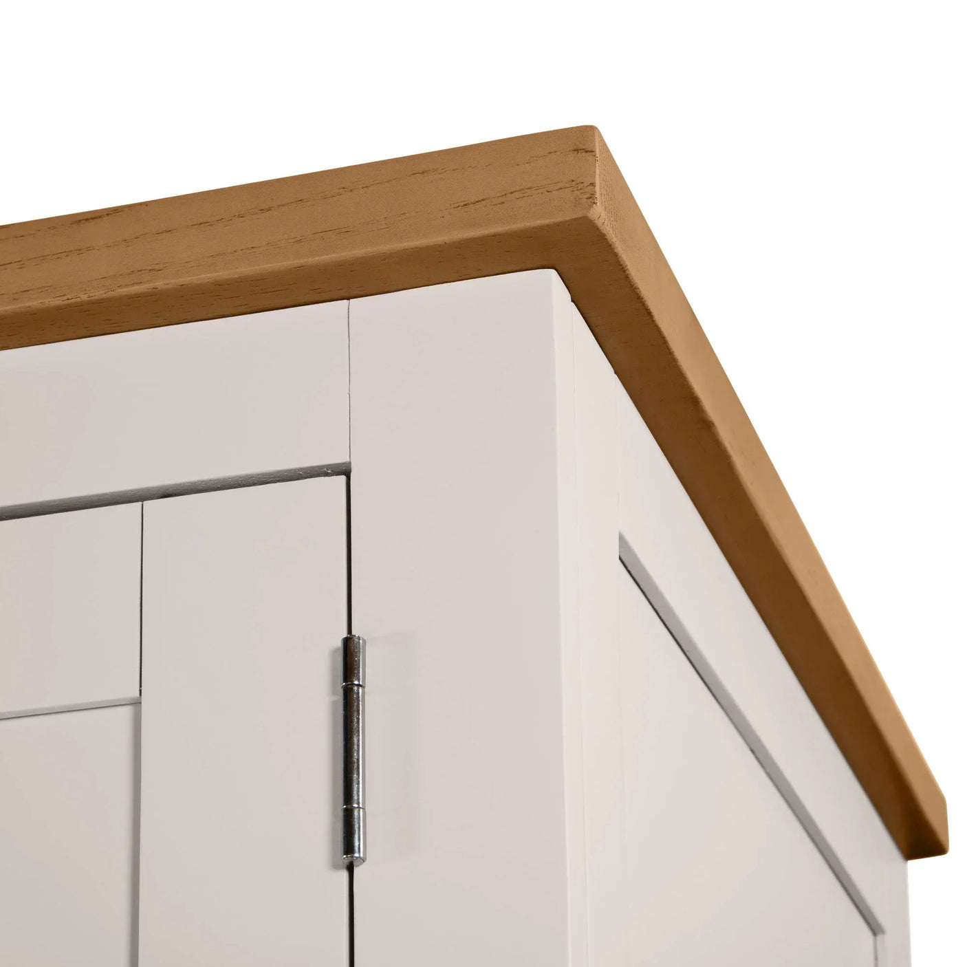 White wooden cabinet corner with light oak top and chrome door hinge detail