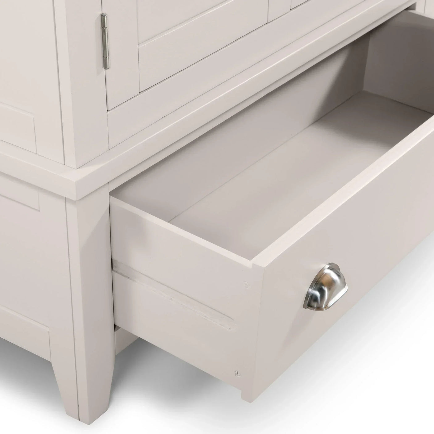 White wooden storage cabinet with open drawer and silver cup handle, close-up view