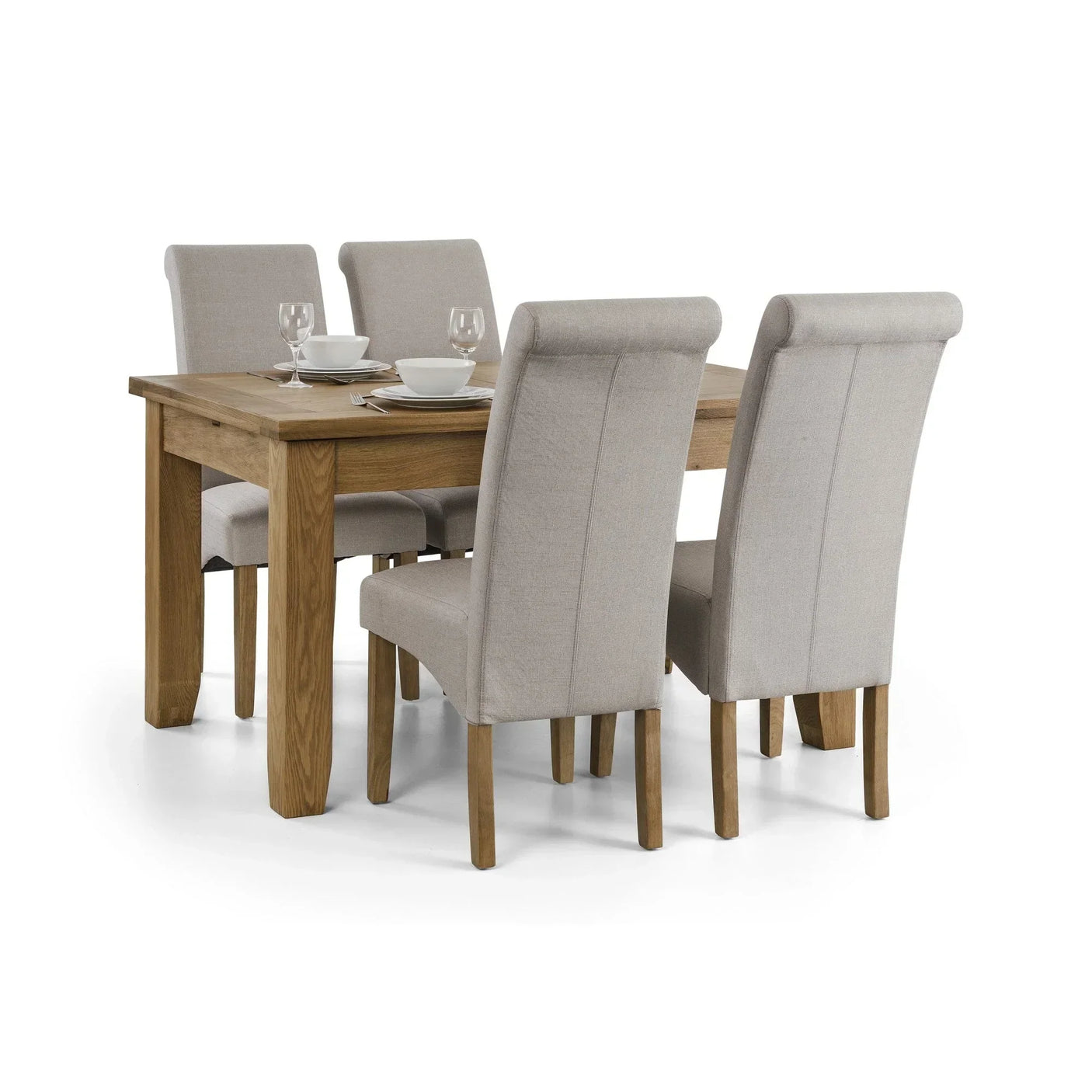 Oak dining table set with four beige upholstered chairs and tableware