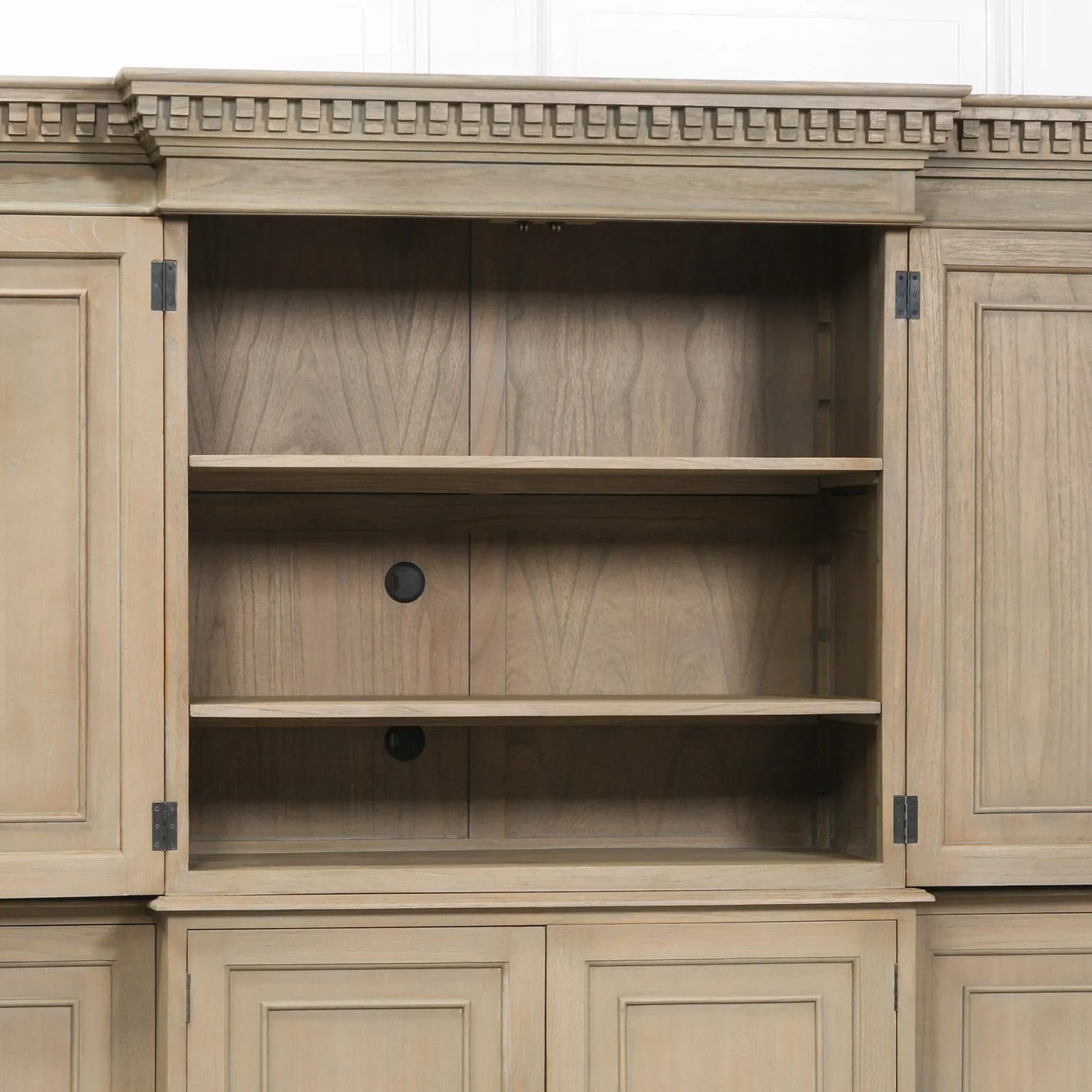 Light wood bookcase cabinet with open shelves and decorative cornice detail