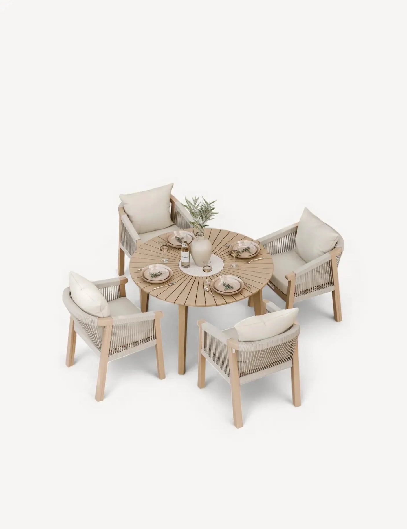 Modern round wooden dining table set with four rope accent chairs and cream cushions