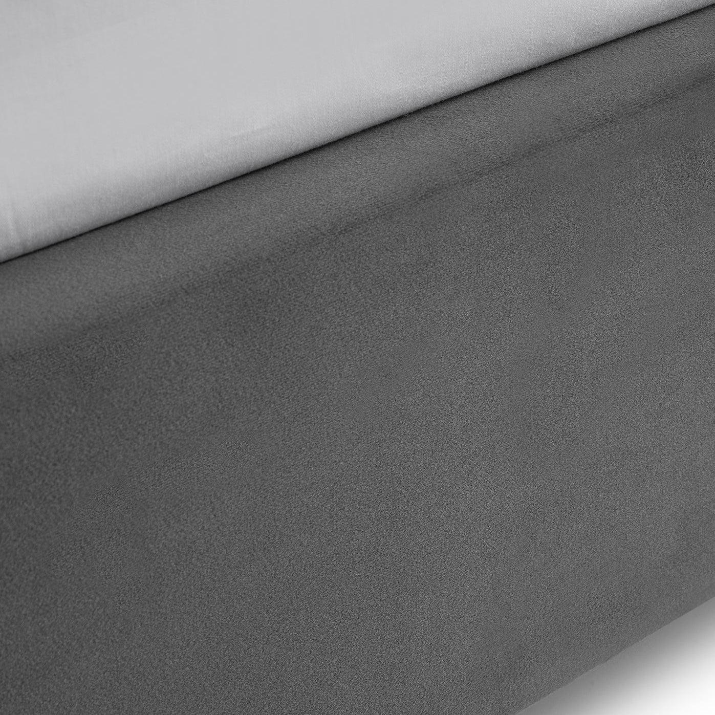 Close-up of grey velvet single bed frame fabric detail