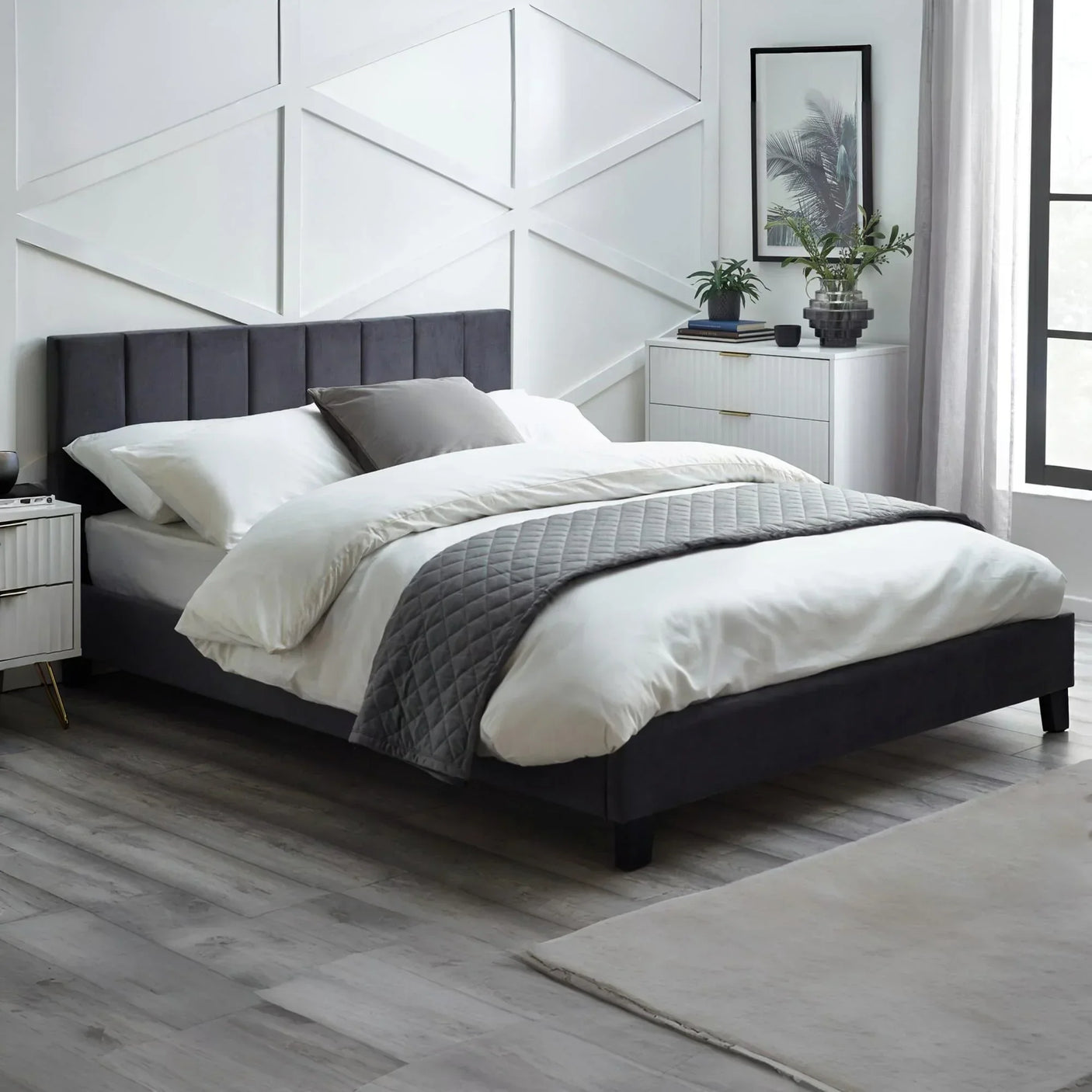Grey velvet double bed with panelled headboard in modern bedroom setting