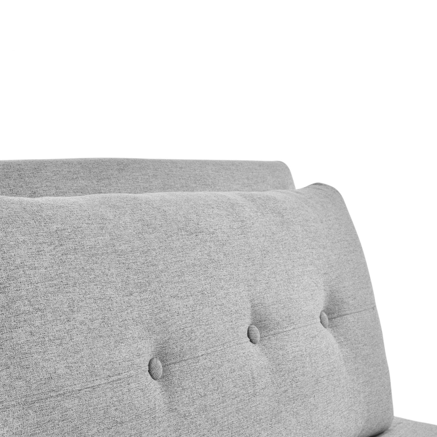 Close-up of grey sofabed backrest with button-tufted fabric upholstery
