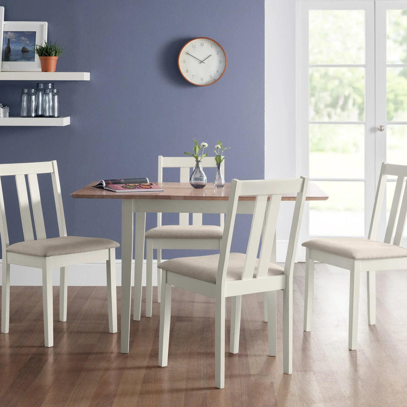White wooden dining table set with four chairs in modern kitchen interior