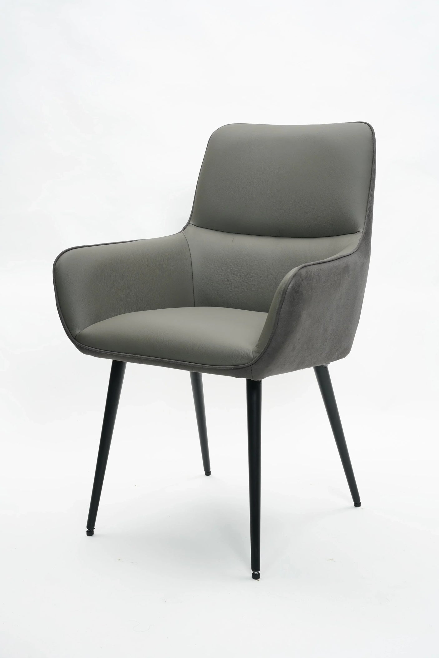 Grey leather dining chair with armrests and slim black metal legs on white background