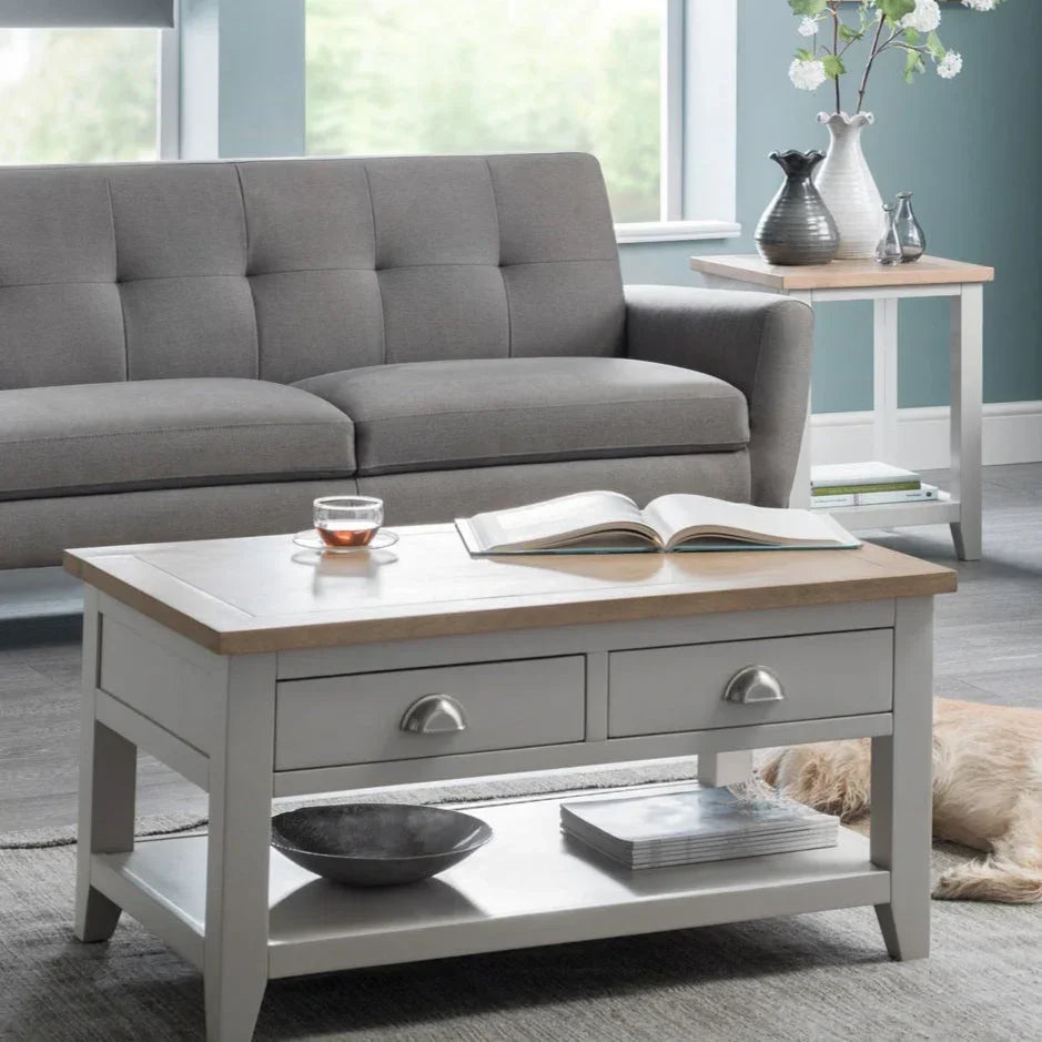 Grey two-seater sofa with light wood coffee table and side table in modern living room