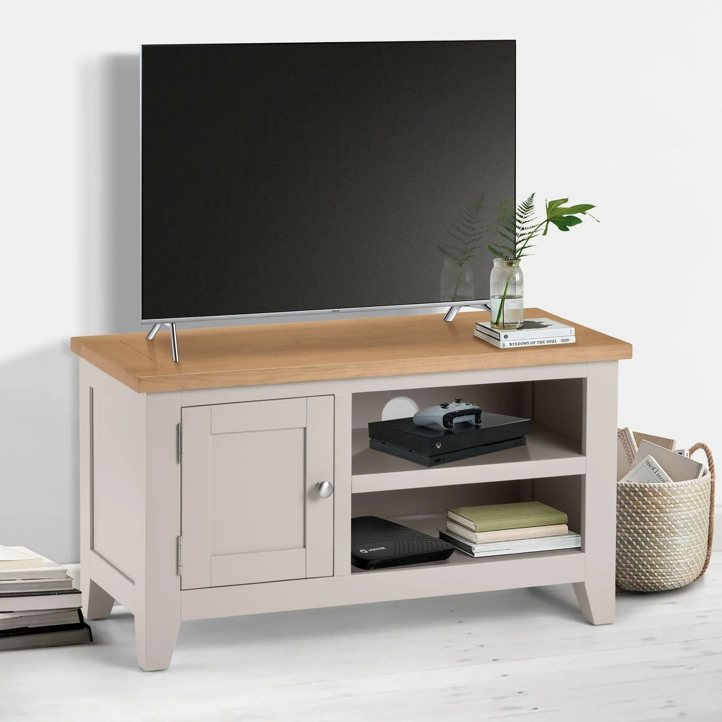 Beige and oak TV unit with shelves, cabinet, and decor in modern living room setting