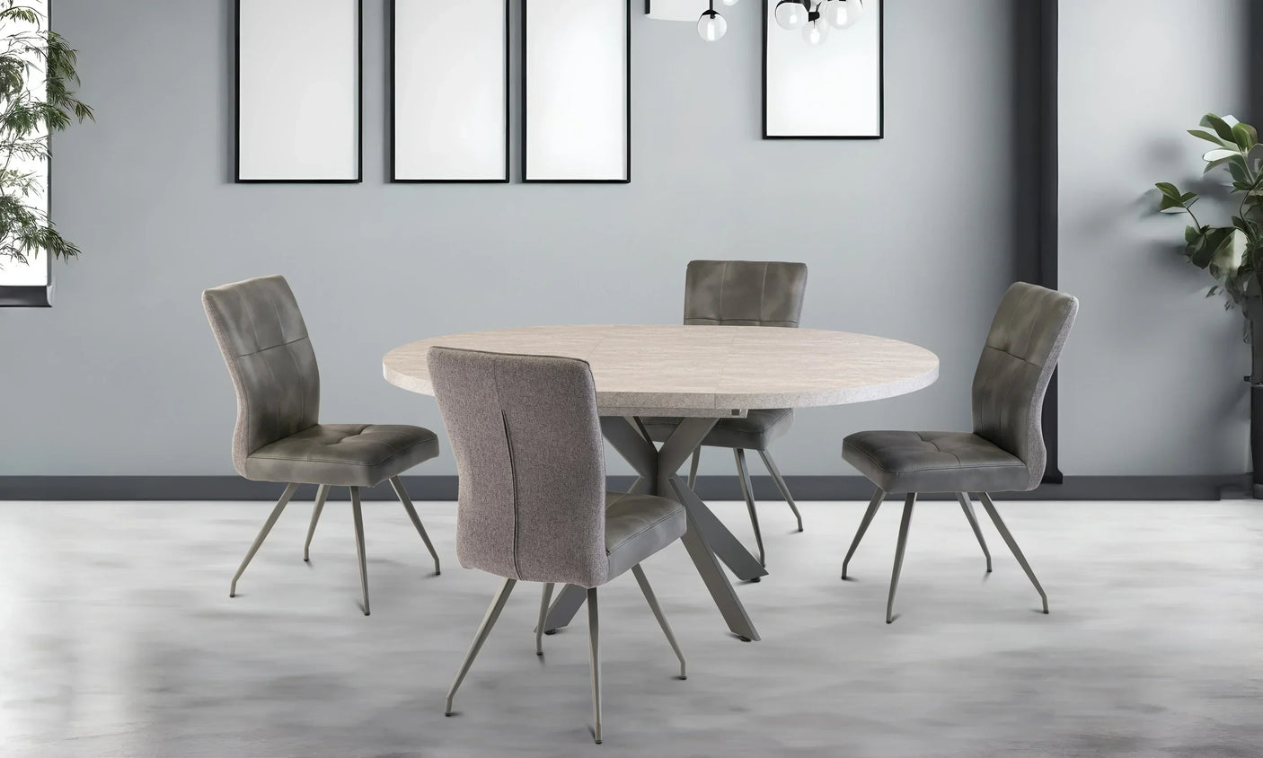 Round dining table with light wood top and four grey upholstered chairs in modern room