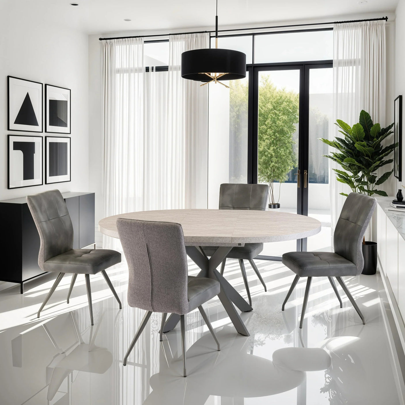 Round dining table with four grey chairs in modern dining room with large windows and plants