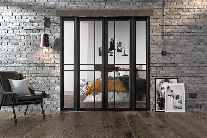 Black metal room divider with glass panels in modern loft bedroom setting