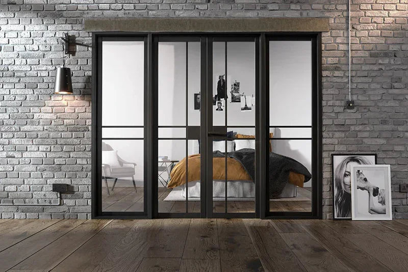 Black framed glass room divider in modern bedroom with exposed brick walls
