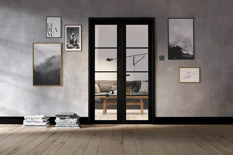 Black metal room divider with glass panels in modern living room, sofa and wall art visible
