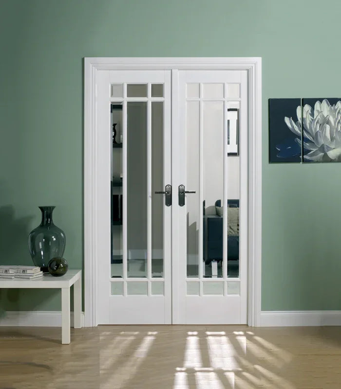 White Manhattan room divider doors with glass panels in a modern living space