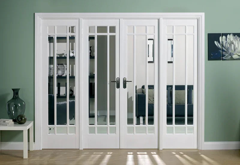 White Manhattan room divider doors with glass panels separating living spaces