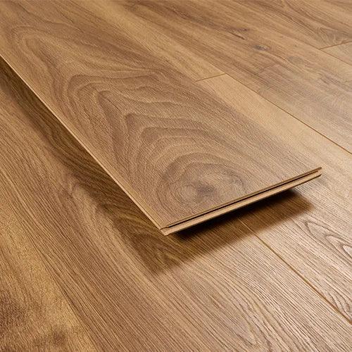 Oak effect laminate flooring plank with wood grain finish on installed floor