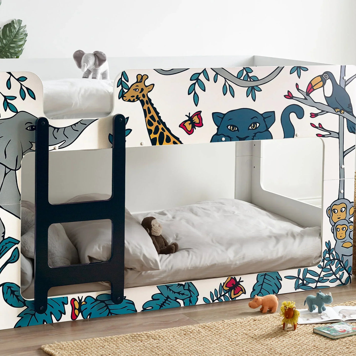 Safari bunk bed with animal illustrations, ladder, and plush toys in a children's bedroom