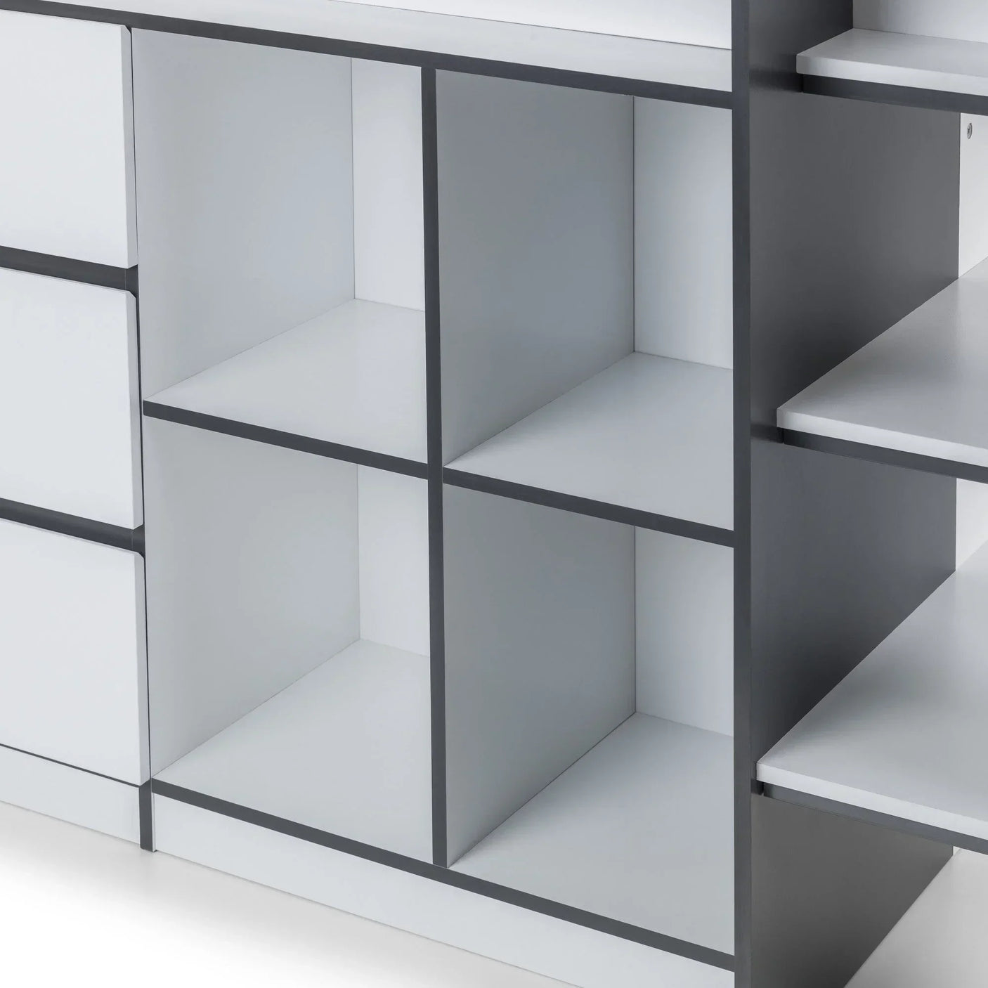 Close-up of a white storage unit with square shelving compartments and grey trim