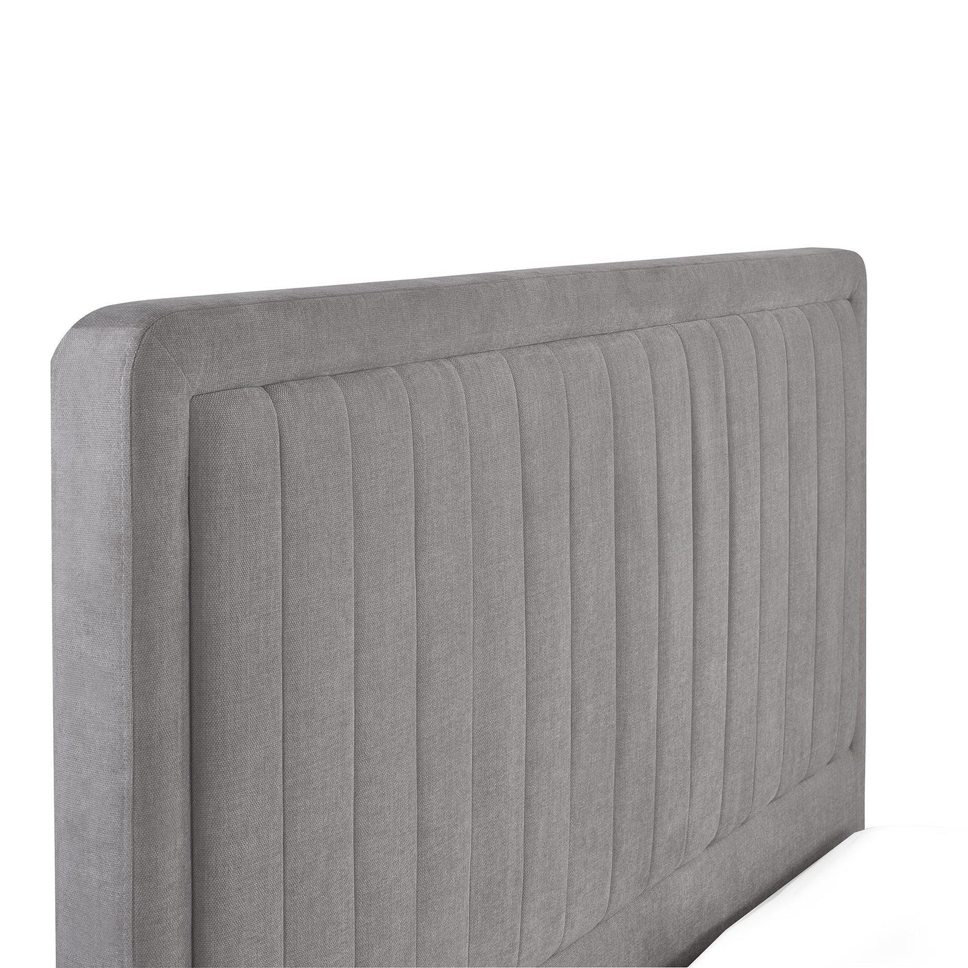 Light grey upholstered bed headboard with vertical stitching detail