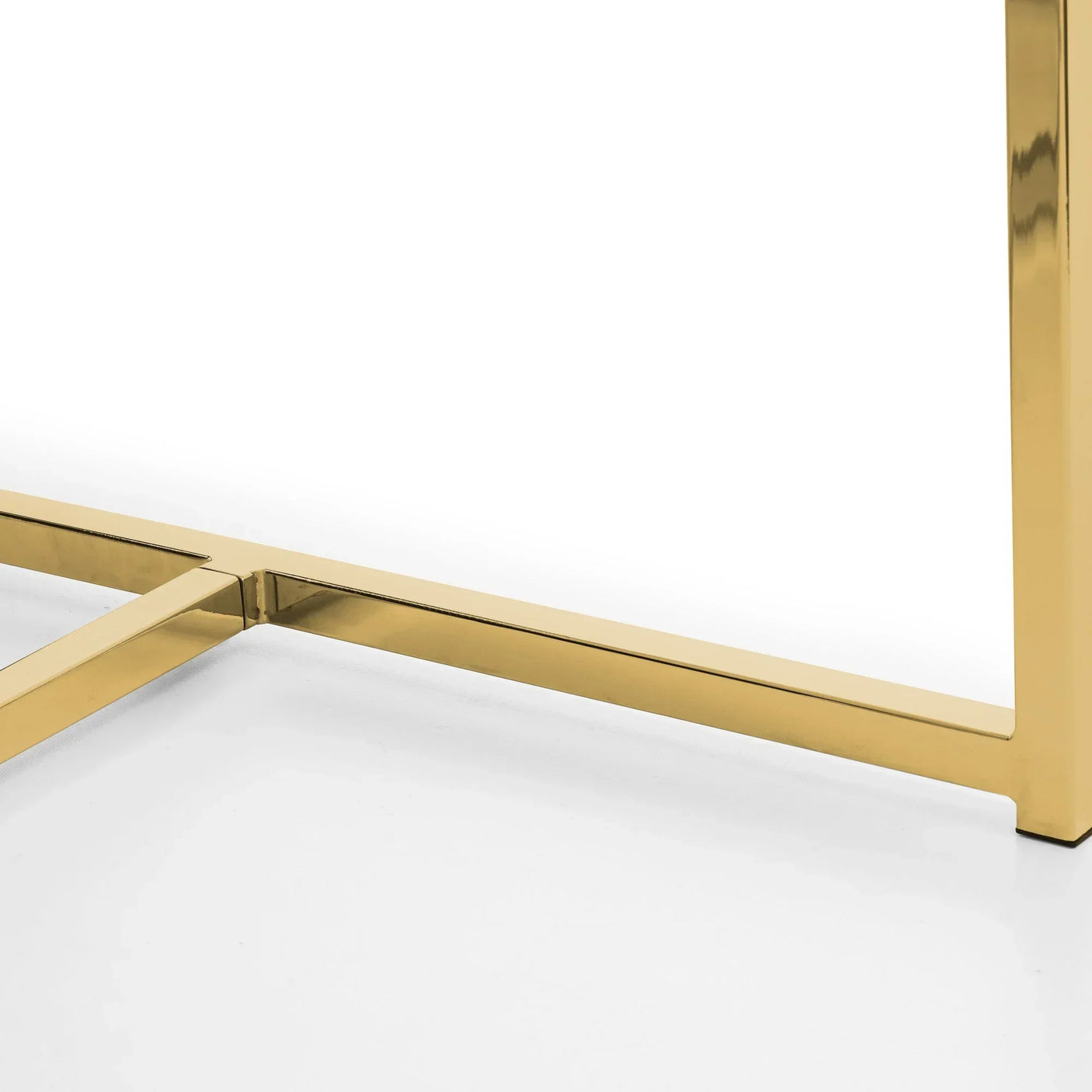 Close up of gold metal table leg base detail on white background