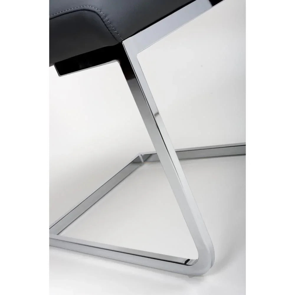 Grey dining chair with chrome metal cantilever legs, close view of frame and stitching