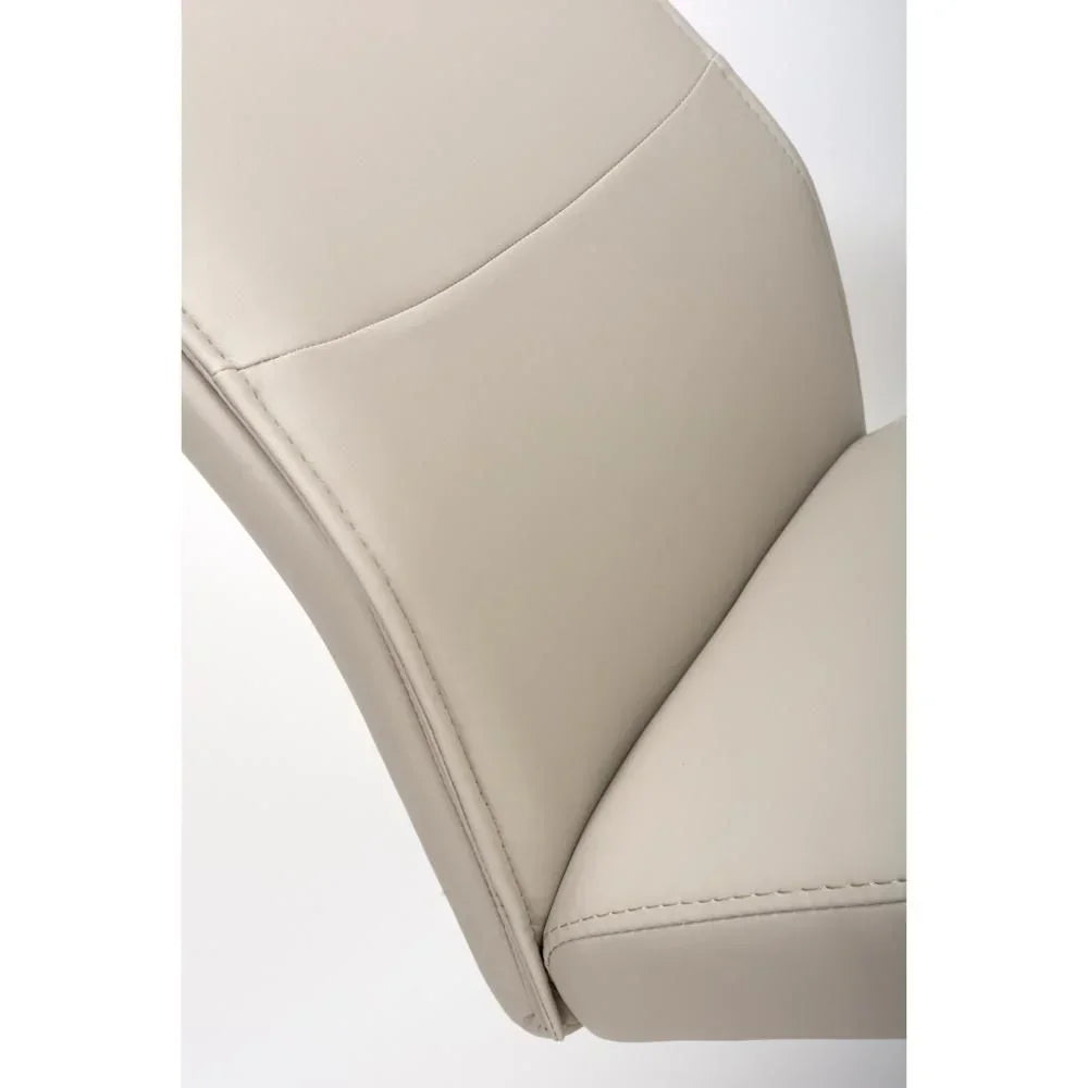 Closeup of beige faux leather dining chair backrest and seat stitching detail