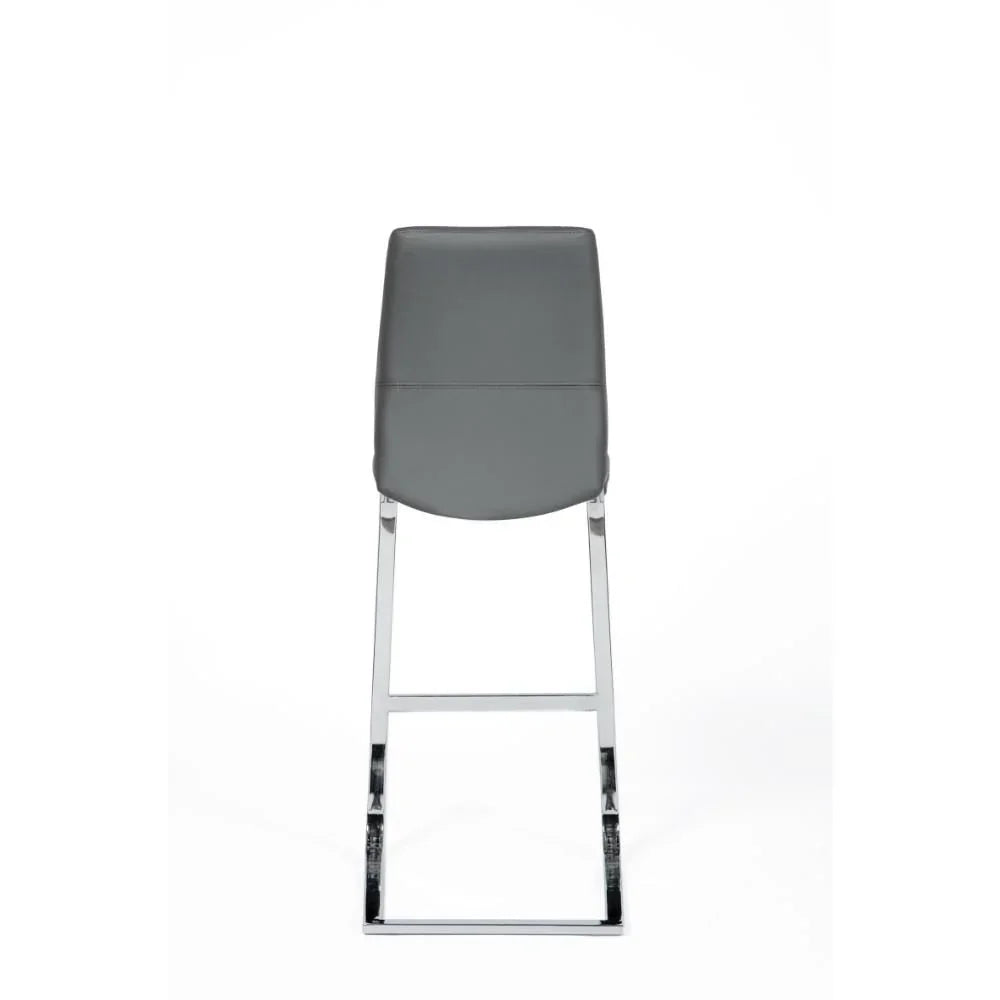 Grey bar stool with chrome legs, rear view, featuring sleek modern faux leather seat