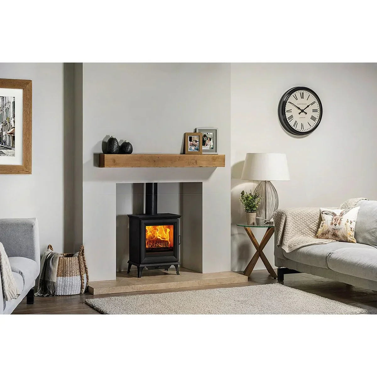 Modern living room with black wood burning stove, beige sofa and mantelpiece decor