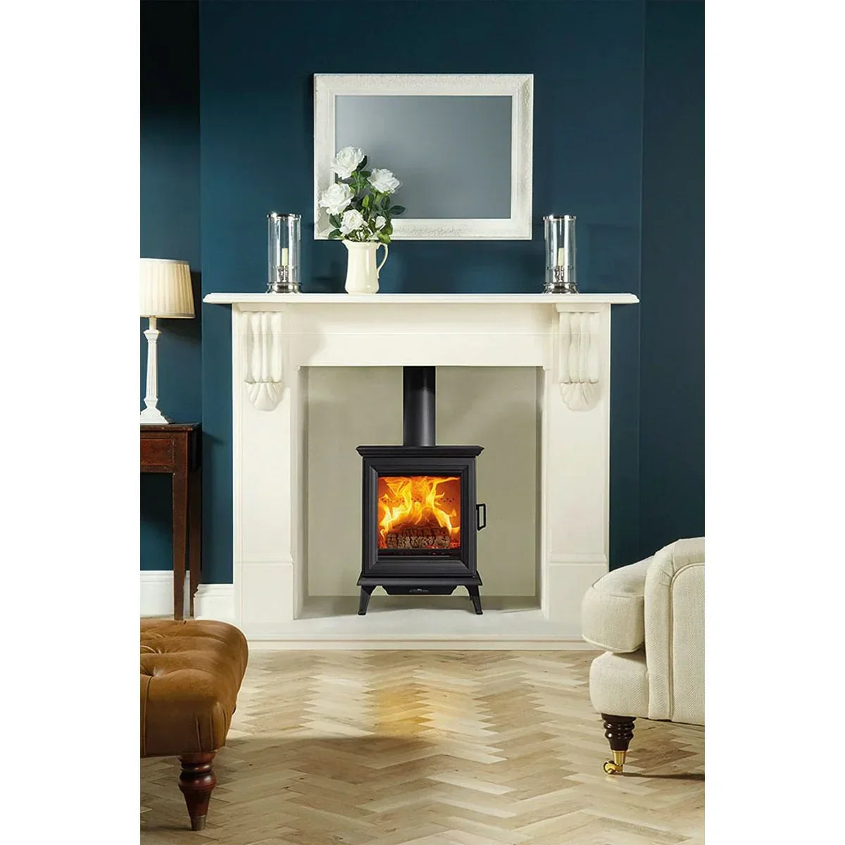 Modern electric stove heater in black with flame effect set in white fireplace surround